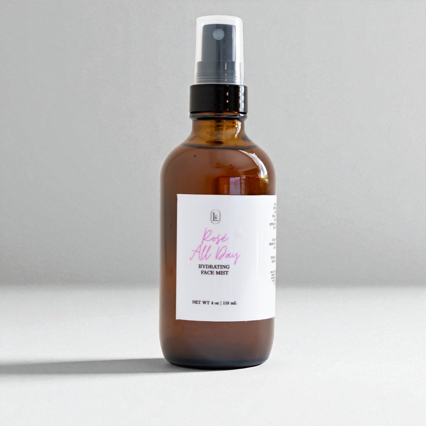 Brown spray bottle with a white label on a gray background