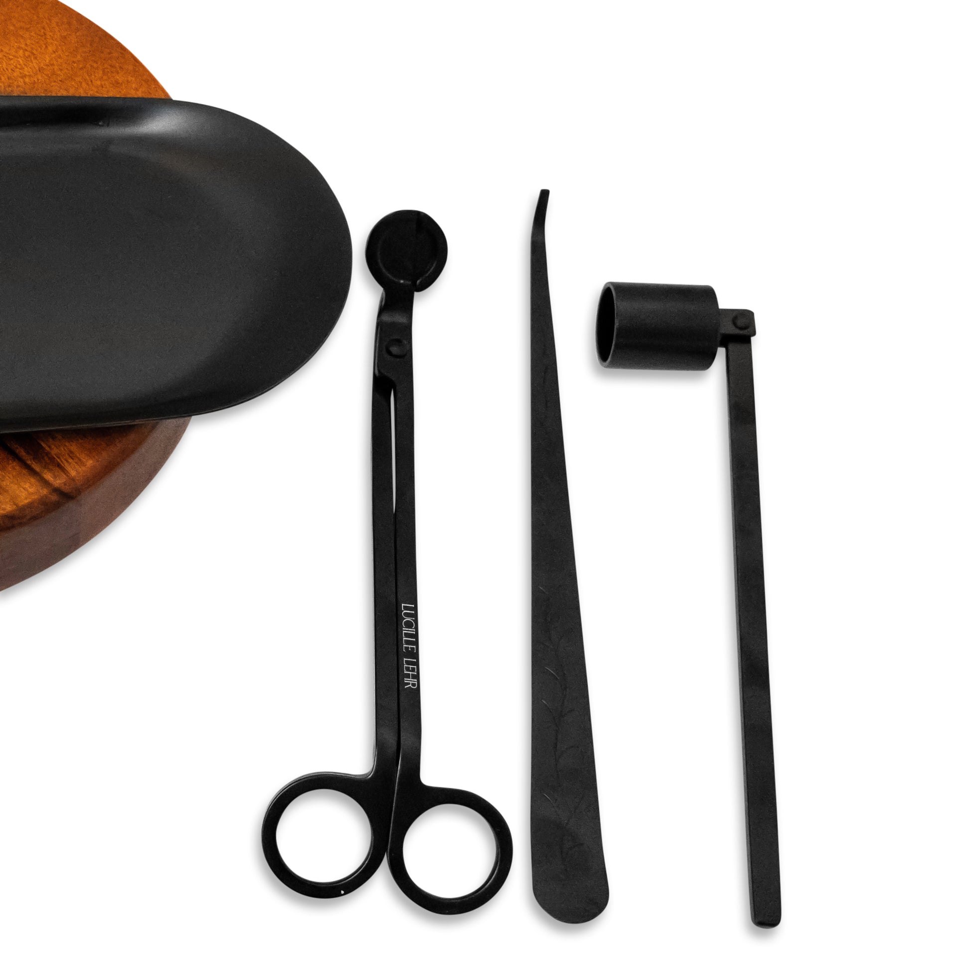 Lucille Lehr Candle Care Essentials: This sleek black candle care set includes a wick trimmer, wick dipper, and candle snuffer, all designed to maintain your candle's longevity and ensure a clean burn. Paired with a minimalist black tray, these tools add elegance and functionality to your candle ritual.