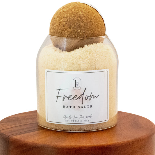 Lucille Lehr's 'Freedom' Bath Salts: Refresh your senses with the 'Freedom' bath salts, crafted to provide a soothing and revitalizing experience. Packaged in a clear jar with a rustic wooden sphere lid, these bath salts are perfect for relaxing and nourishing the soul, bringing tranquility to your self-care routine.