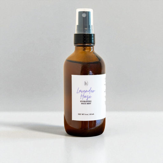 Brown spray bottle labeled 'Lavender Haze Hydrating Face Mist' on a light gray background