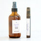 Brown glass bottle and black tube with white label of Lavender Haze Hydrating Face Mist on a light background