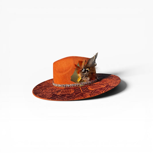 Orange hat with feather and decorative band on a white background