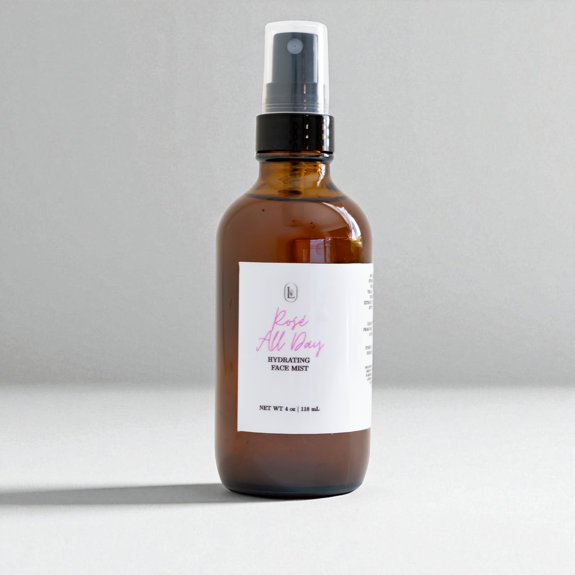 Brown spray bottle with a white label on a gray background